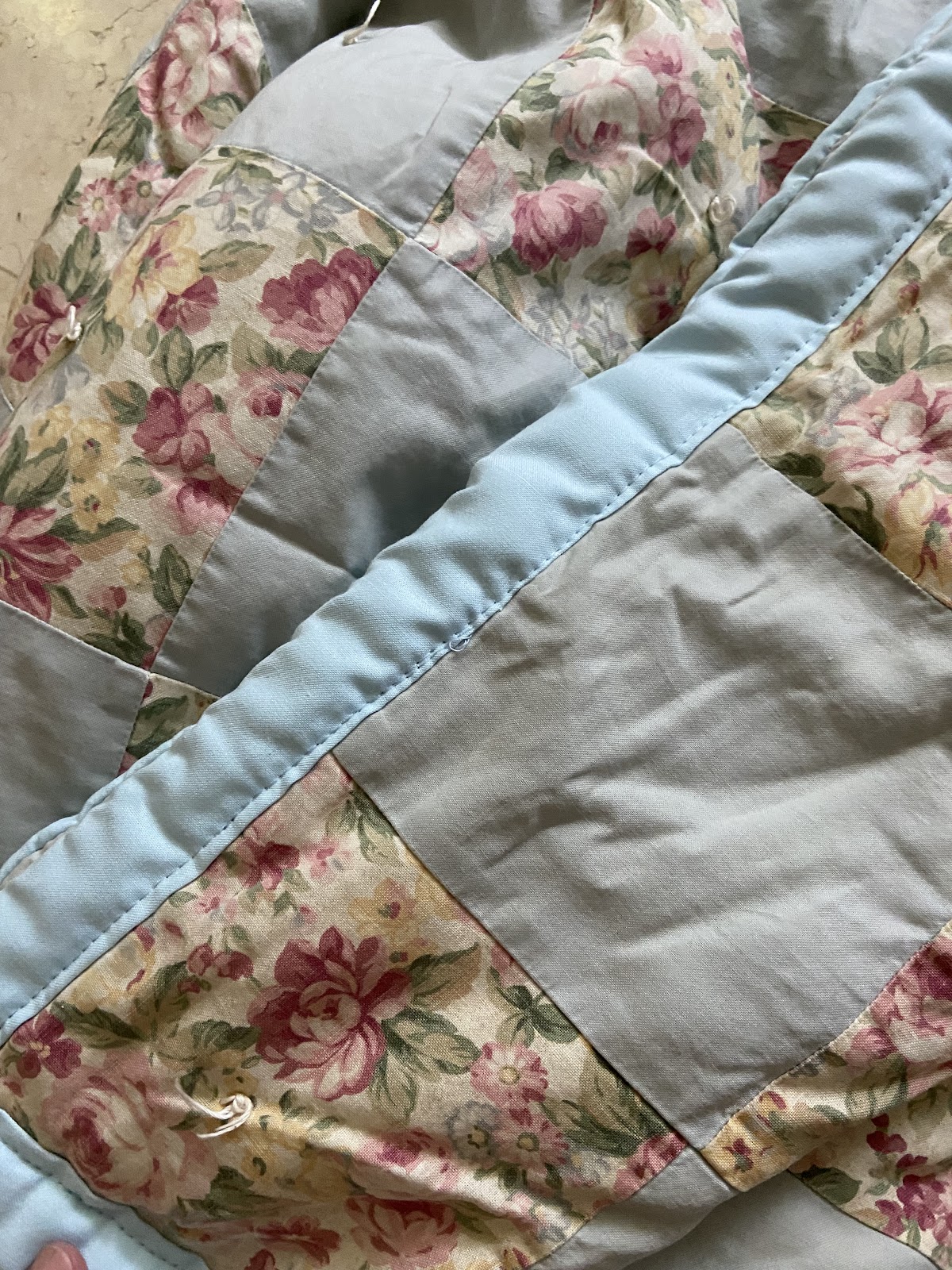 A floral patchwork quilt sewn at the shop